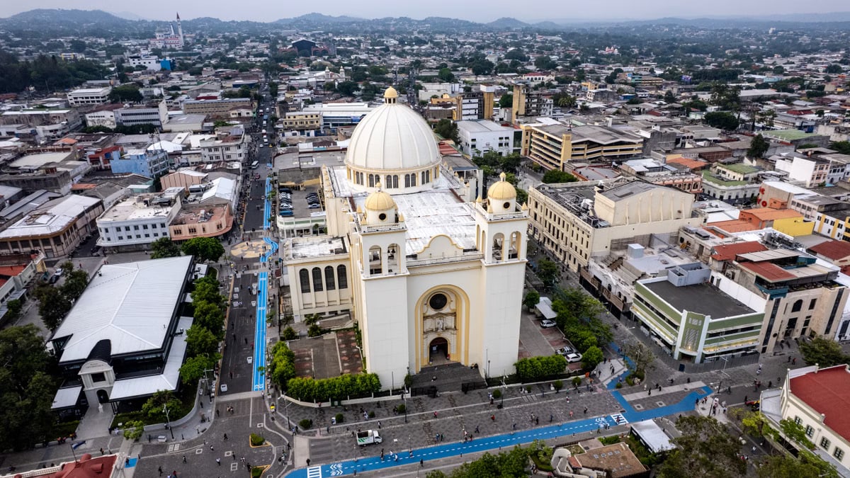 Aerial shot of the Metropolitan Cathedral in San Salvador's historic center, showcasing cityscape and urban architecture.
